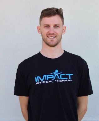 Male physical therapist wearing Impact Physical Therapy t-shirt.